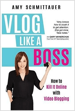 Amy Landino escreveu o livro Vlog Like a Boss com o nome de Amy Schmittauer. A capa mostra uma foto de Amy da cintura para cima segurando uma câmera de vídeo. O título aparece em um fundo azul claro com letras brancas e fúcsia. O slogan do livro é How To Kill It Online With Video Blogging.