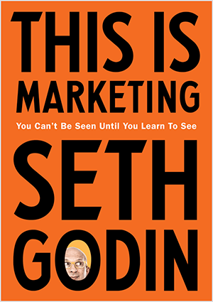 Esta é uma captura de tela da capa de This Is Marketing, de Seth Godin. A capa é um retângulo vertical com fundo laranja e texto preto. Uma foto da cabeça de Seth aparece no O de seu sobrenome.